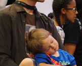  Caption: Kyle, 1, sacked out in his father's arms.