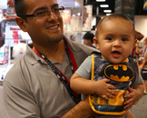  Caption: Emir Escobar holds Jocsan, 7 months, who seems pleased with his Batman bib.