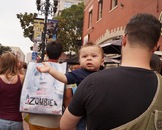  Caption: A baby in the Gaslamp District seems unfazed by the crowds.  